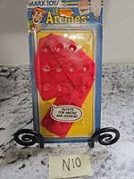 Full front view of sealed blister card with red outfit