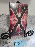 Front view of sealed X-Files VHS tape on stand