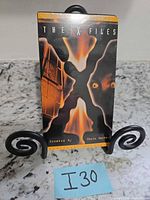 Front cover of sealed The X-Files VHS tape on stand