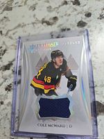 Front of card showing player image, jersey swatch, holographic foil, number 48