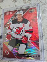 Front of Upper Deck Allure Red Rainbow Jack Hughes card in sleeve