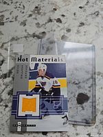Front view of Kevin Dallman Hot Materials jersey card with yellow swatch in sleeve