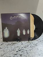 Front cover with vinyl partially out of sleeve