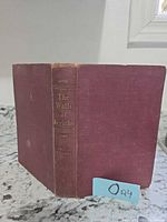 Front view of maroon hardcover book showing spine title and author