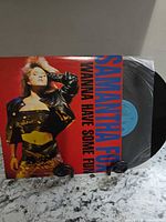 Front jacket showing album art, record partially removed displaying label