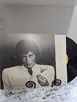 Front jacket artwork and exposed vinyl record