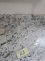 overall view of acrylic stand showing six posts and circular tops