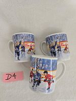 Three Tim Hortons hockey coffee mugs front view
