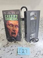 Front of Creepy Crawlers VHS slipcover with lenticular image and tape side view