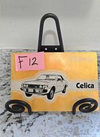 Front cover of 1974 Toyota Celica owner’s manual on stand