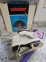 Overall view of skates, guards, and original box