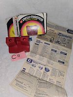 Viewer, box, paperwork and blue accessory displayed