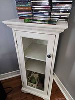 Front view of white single-door cabinet with glass panel