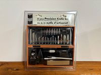 Front view of sealed 35-piece precision knife set in case