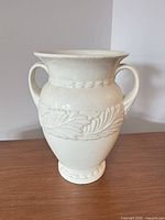 Front view of cream glazed Abingdon vase showing double handles and leaf motif
