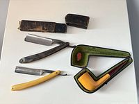 Full lot showing two razors, pipe in open case, razor box