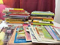 Stacks of beading books and magazines displayed on table