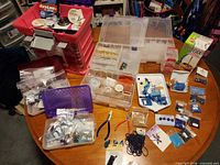 Overall view of storage units, beads, tools and thread on table