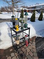 Overall view of eight assorted bird feeders on shelving