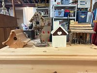 Group shot of all four wooden birdhouses on table
