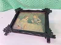 Framed print with rustic wooden frame and image of two children on bed