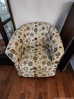 Front view of patterned upholstered tub chair