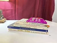 Stack of six cartoon books showing spines