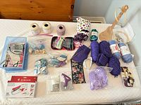 Overview of entire lot showing Singer machine, glue gun, yarn, tools