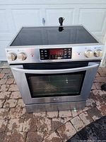 Front view showing stainless steel finish, oven door, control panel and knobs