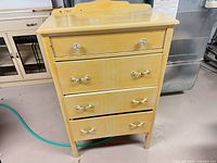 Front view of highboy chest showing four drawers, hardware, colour, wear