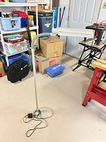 Full view of Ott-Lite floor lamp showing base, pole, flexible neck and lamp head with power cord