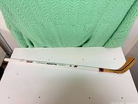 Full view of the 53-inch Ottawa Sports Radio Ottawa Senators collectors edition wooden hockey stick on white surface