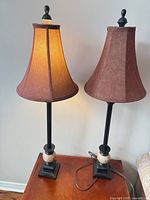 pair of tall table lamps on table