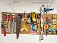 Overall view of pegboard with grouped hand tools and hardware