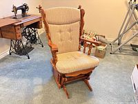 Front view of wooden platform rocker with beige upholstered seat and back