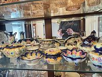 Overview of approx. 15 hand-painted Royal Nippon porcelain pieces on glass shelf