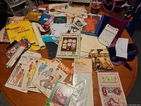 Table view showing mix of sewing patterns, craft booklets, fabrics and notions