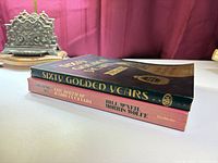 Two hardcover books stacked showing spines