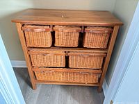 Front view of pine dresser with six wicker baskets