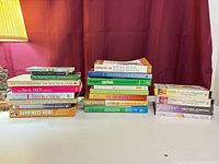 Overall view of both stacks of books and four VHS tapes