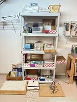 Full shelf unit showing grinder, soldering iron, stained glass flats, storage bins