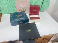 Group shot showing all four Trivial Pursuit boxes on table