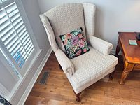 Front view of wingback armchair with pillow