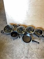 Full set of pans and lids lined up