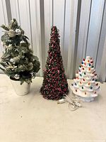 All three tabletop trees side by side for scale and variety