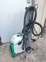 Full left side view showing main unit, hose, power cord