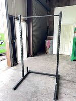 Full view of freestanding pull-up rack showing uprights, pull-up bar and base
