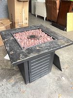 Overall view of fire table with lava rocks and burner