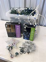 Entire lot showing tote of lights, two GE boxed sets, star topper, tinsel sphere