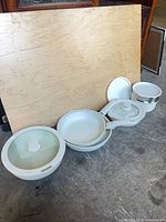 Entire cookware set lined up showing pots, pans, and lids